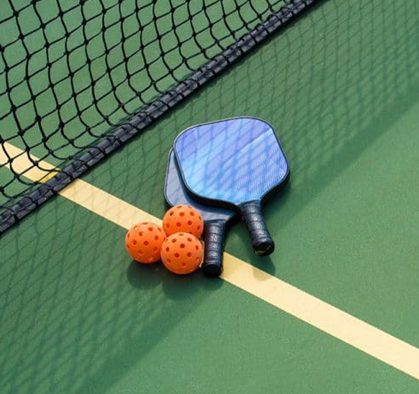 Pickleball Rackets and Balls placed on the court