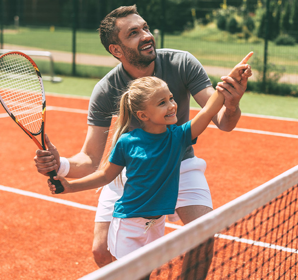 Father and Daughter playing tennis
