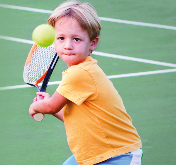 child playing tennis