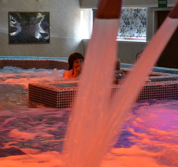 couple relaxing in manor resort hydro pool and spa